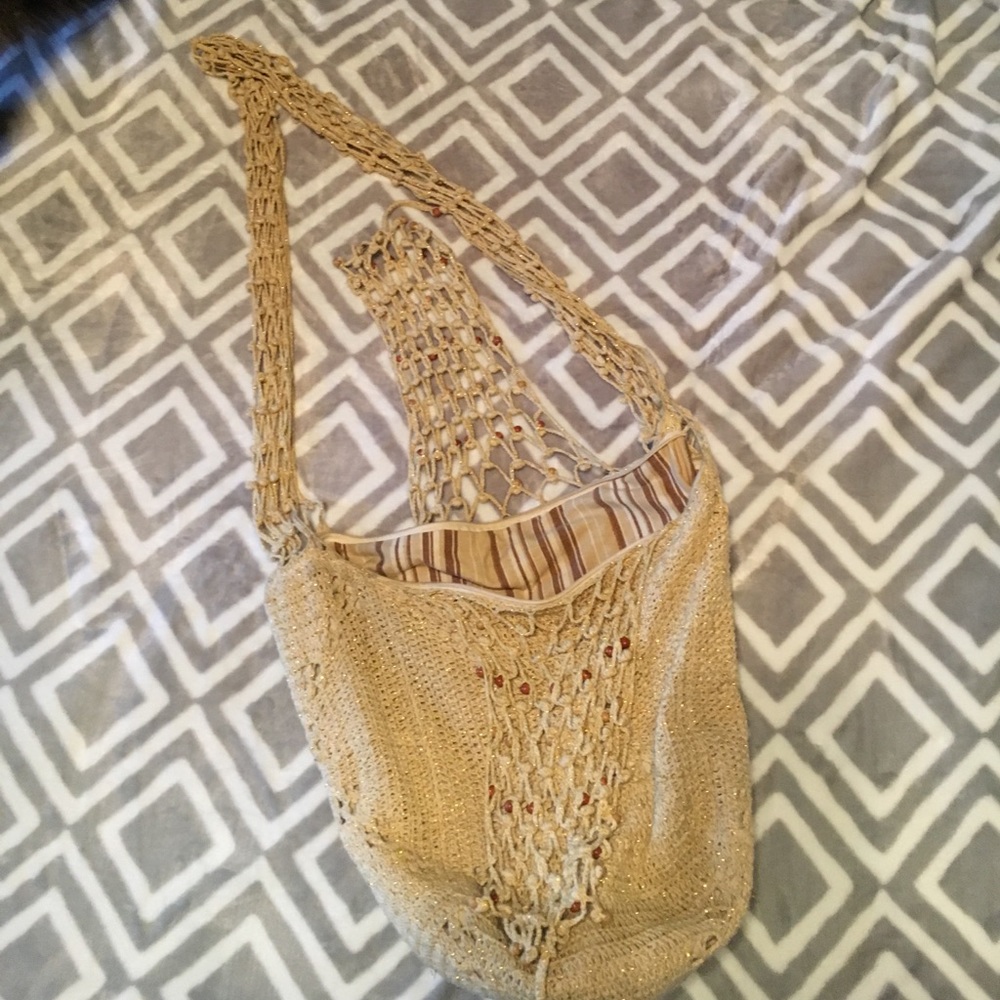 Knot tan purse. Zipper on inside for storage.