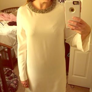 White long sleeved dress with beaded neckline