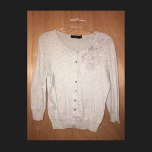 Light grey cardigan with ruffle flower detail