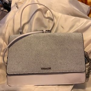 White with black Coach clutch purse.