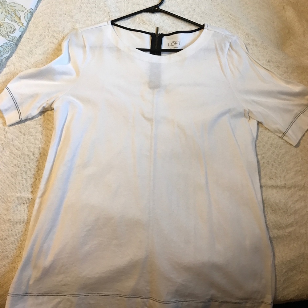 White shirt with zipper back, black stitching.