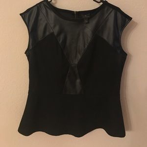 Black peplum top with faux leather accents