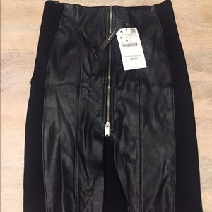 Black mid skirt. Faux leather detail