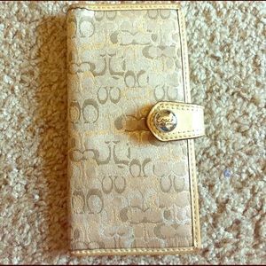 Wallet is tan with brown, gold and silver C's.