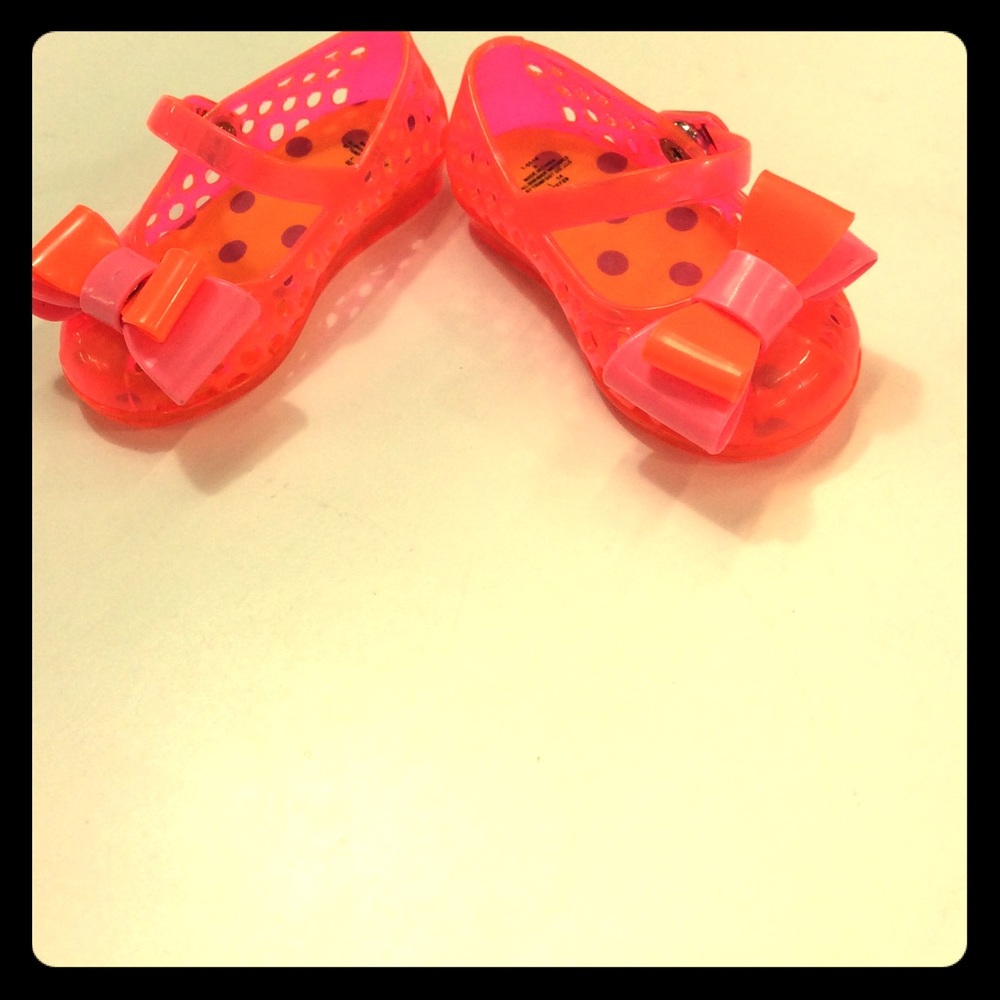 Bright orange baby jelly shoes