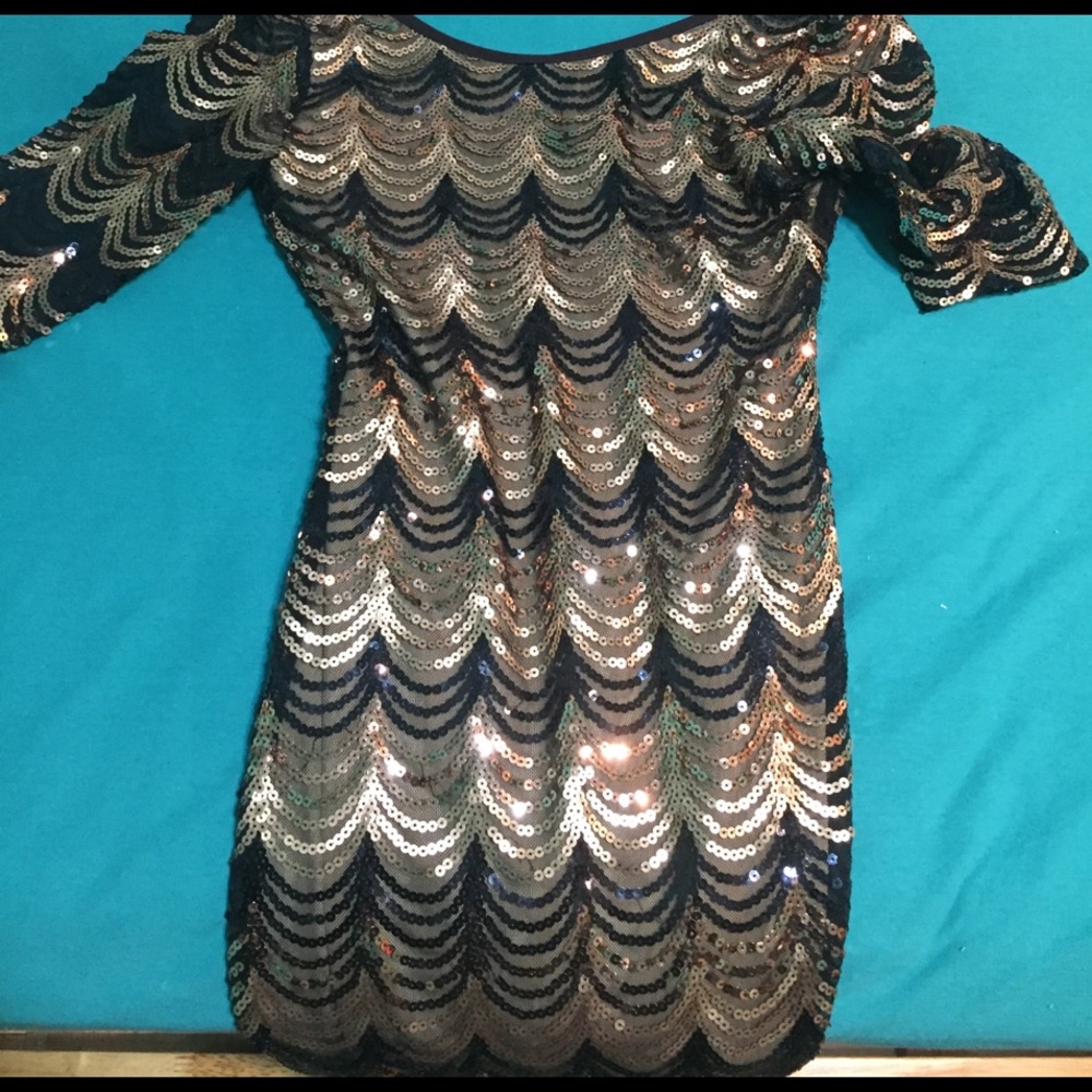This is a black and gold fitted dress