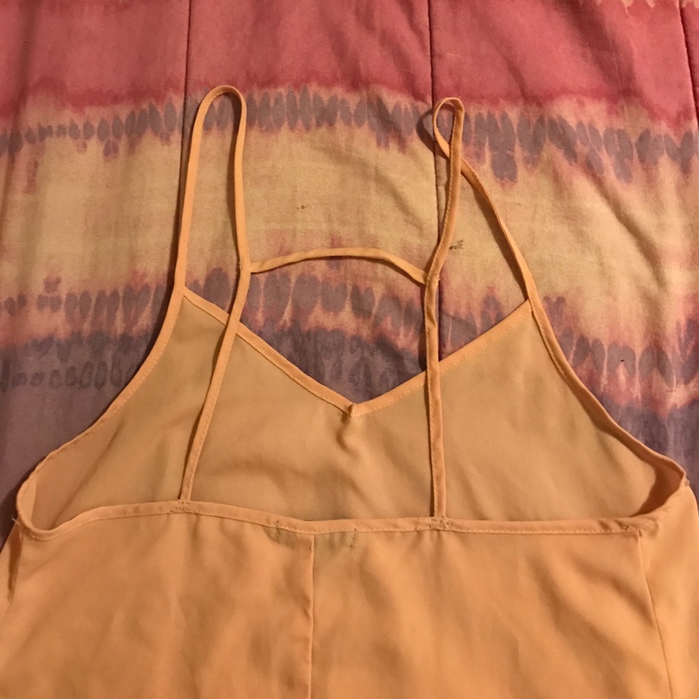 Pink flowy shirt with a caged strapped back