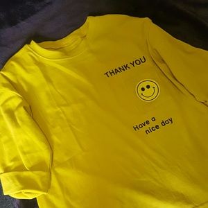 Yellow smiley face t-shirt.