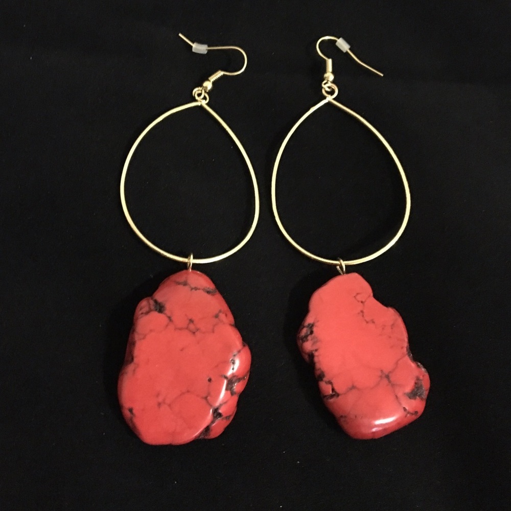 Gold earrings with a red agate