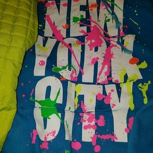 Royal blue hoodie and lime green vest.