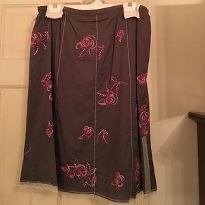 Brown skirt with pink embroidery and lace.