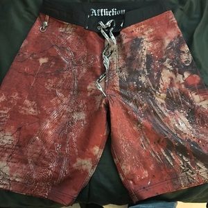 Pair of orange Affliction swim trunks