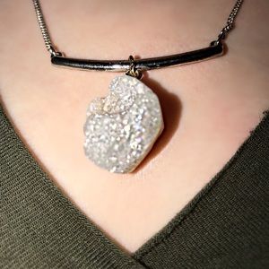 Crystal necklace attached to a silver bar.