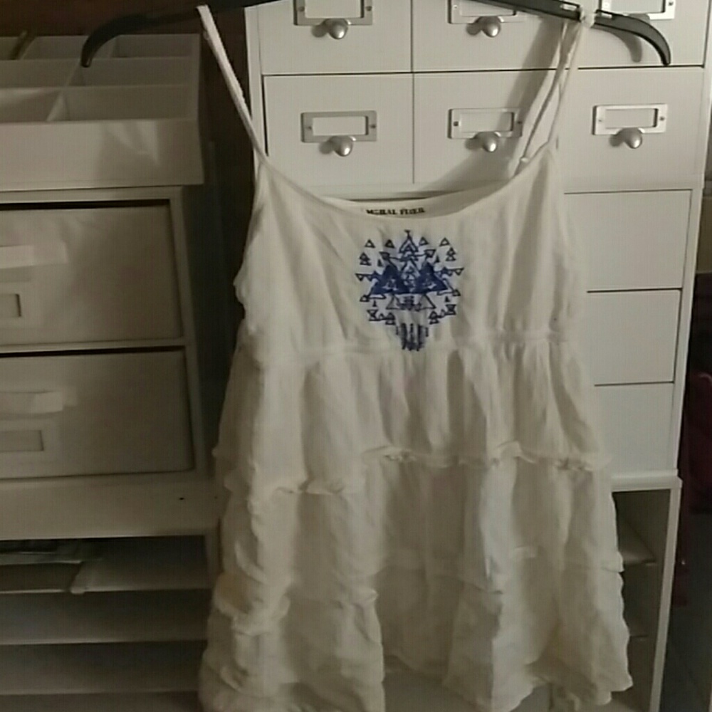 White dress with blue design at top