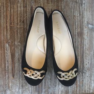 Black flats with gold detailing