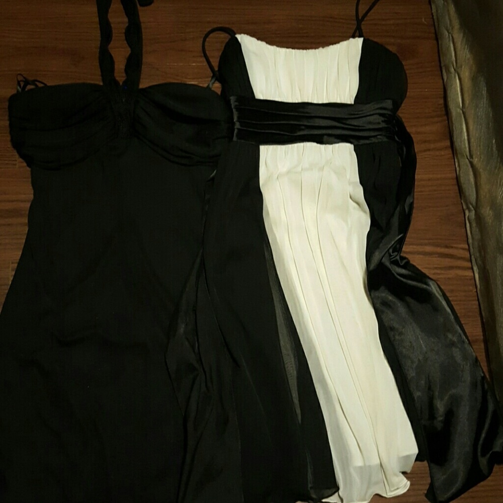 Two black, and one white dress in good condition.