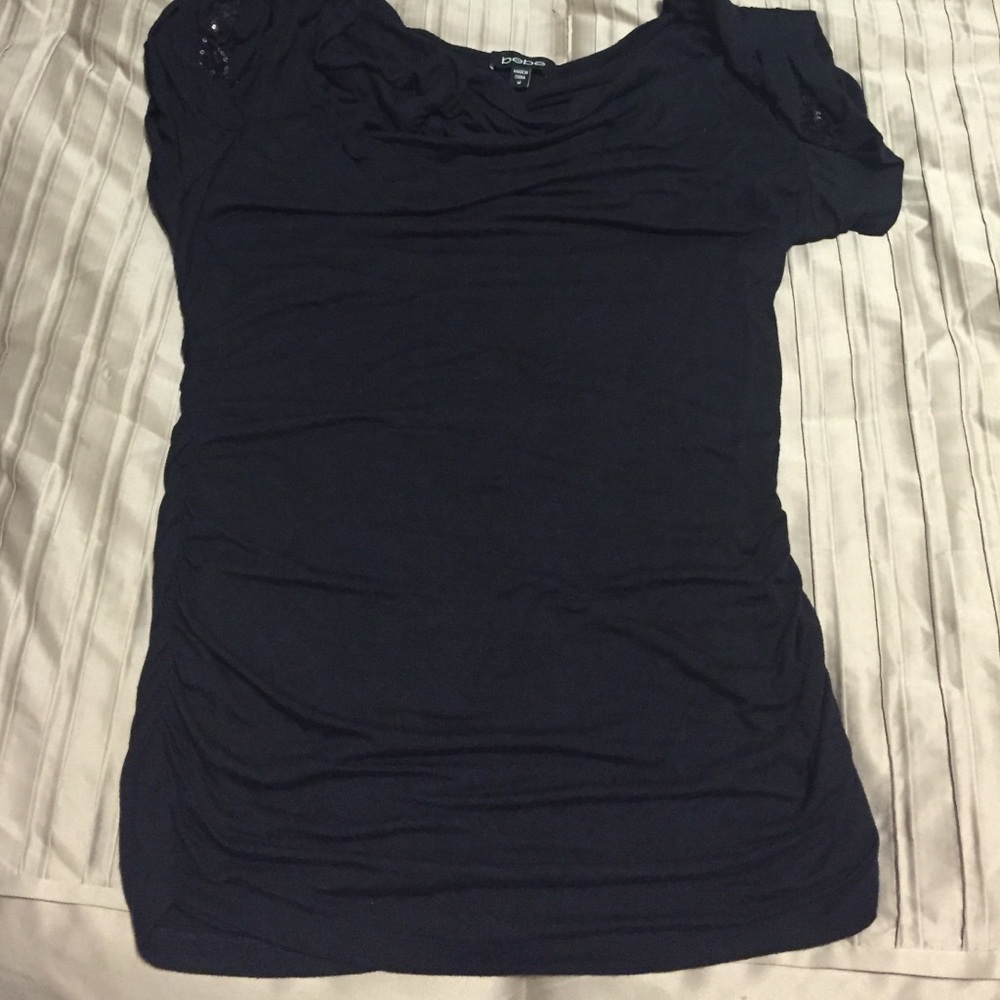 Black BEBE top with sparkling shoulders.