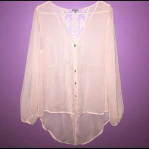Sheer pale pink blouse.