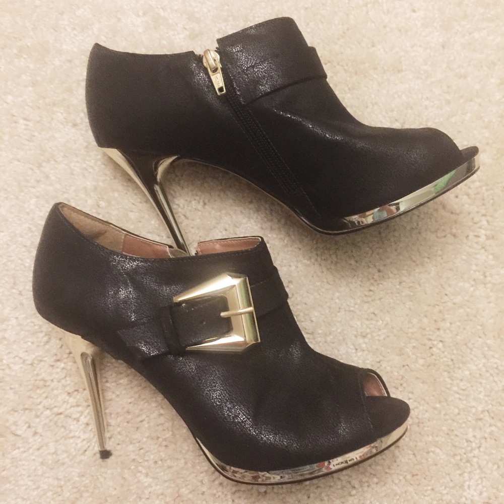 Black ankle boots with golden buckles