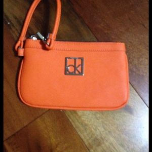 Calvin Klein orange wristlet. Obo