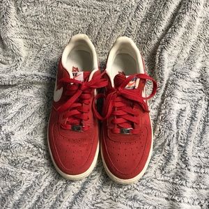 Red low top suede Nike air forces.