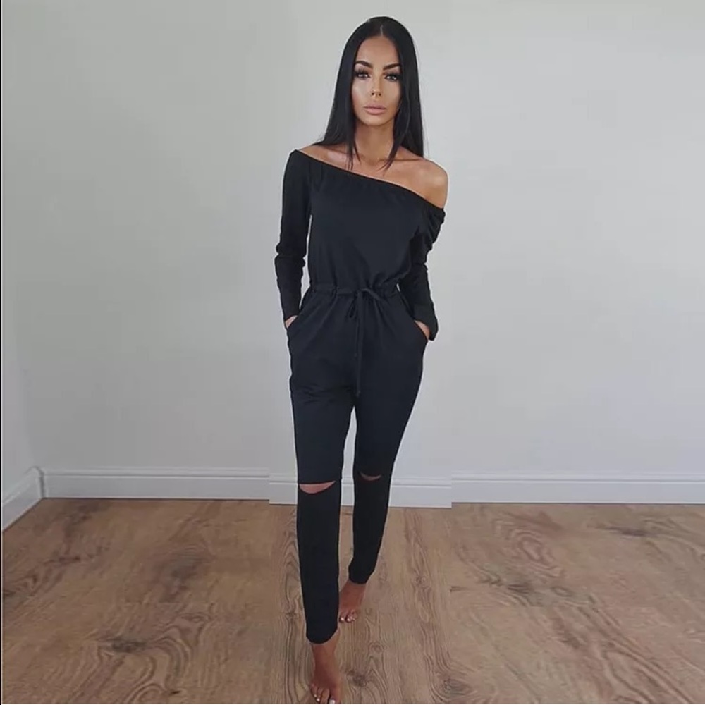 Black off shoulder jumpsuit with cut knees