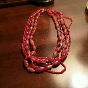 Funky pink bead necklace with a touch of red.