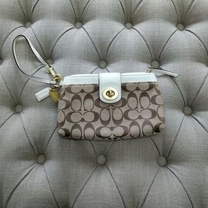 Brown and cream Coach wristlet