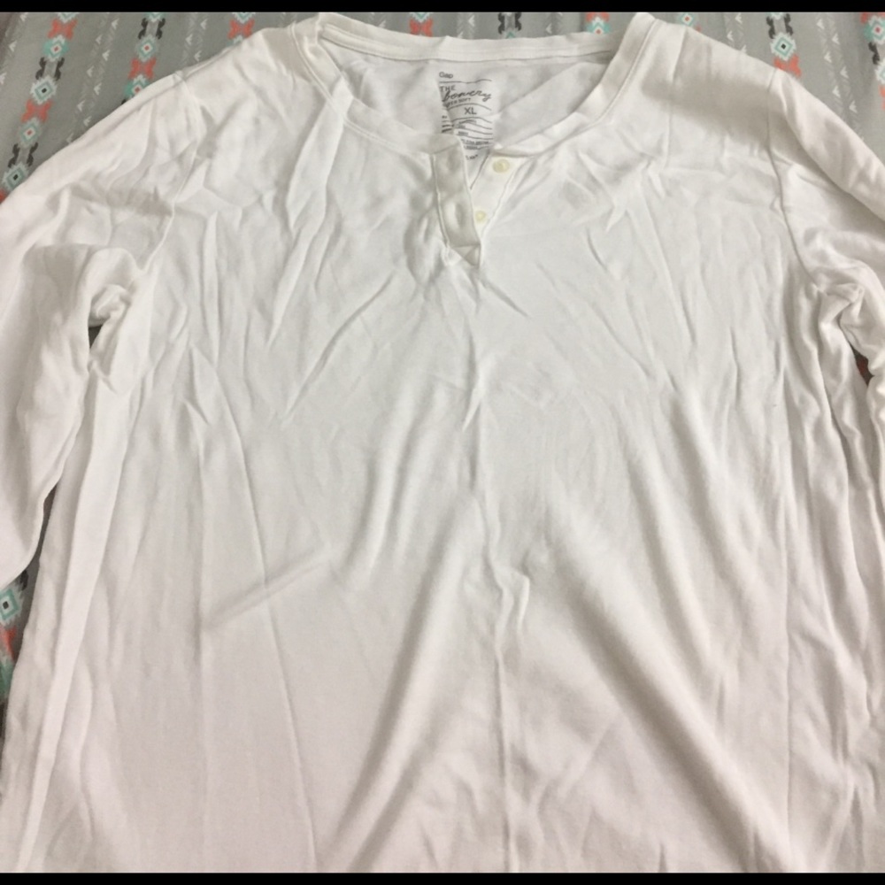 Long sleeve white V-neck with buttons.