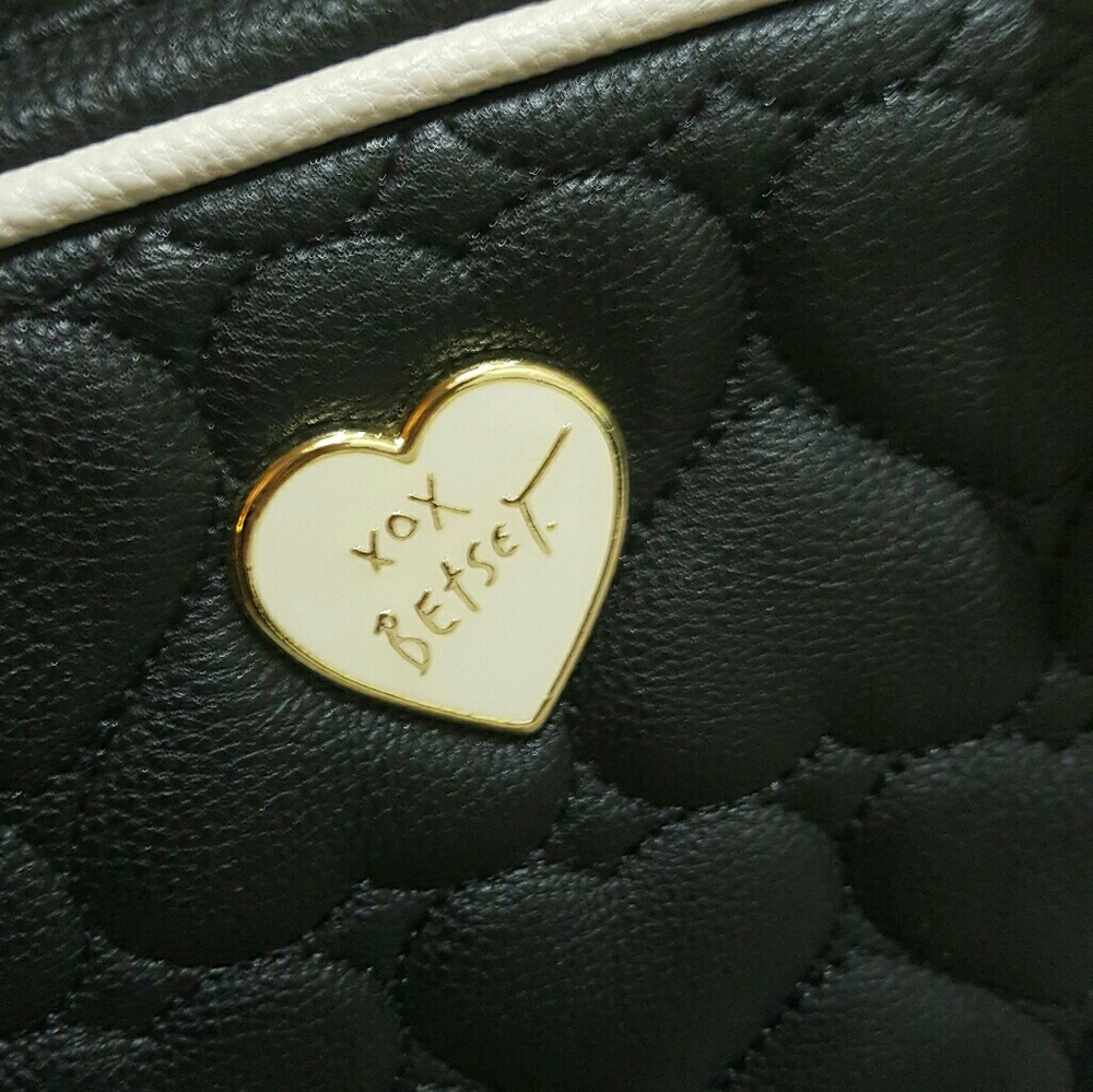 NWOT. Black and white with gold hardware backpack