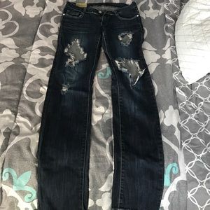 Machine, distressed denim, slight flaw, dark wash