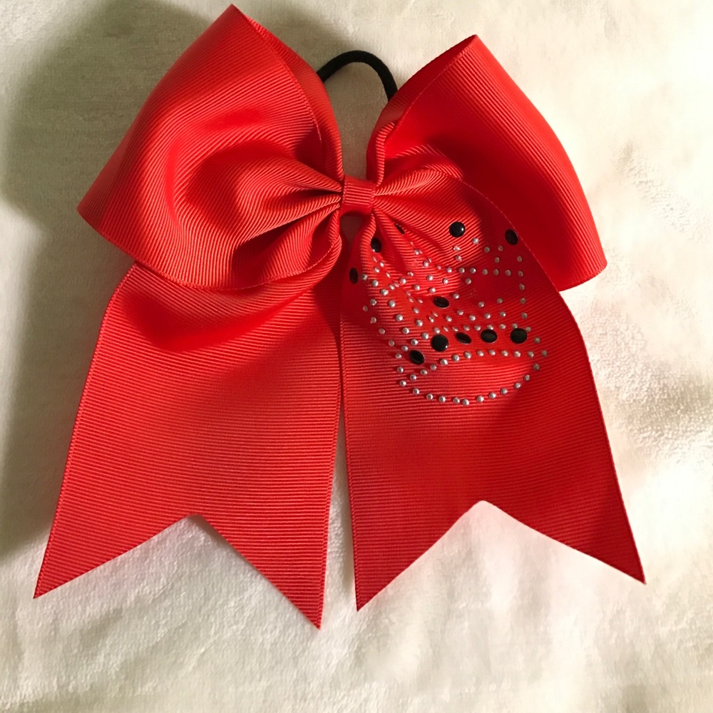 Red cheer bow with crown on it.