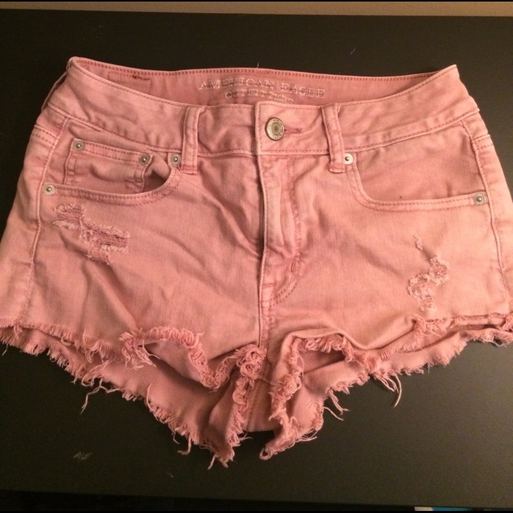Washed out pink vintage high waisted denim shorts