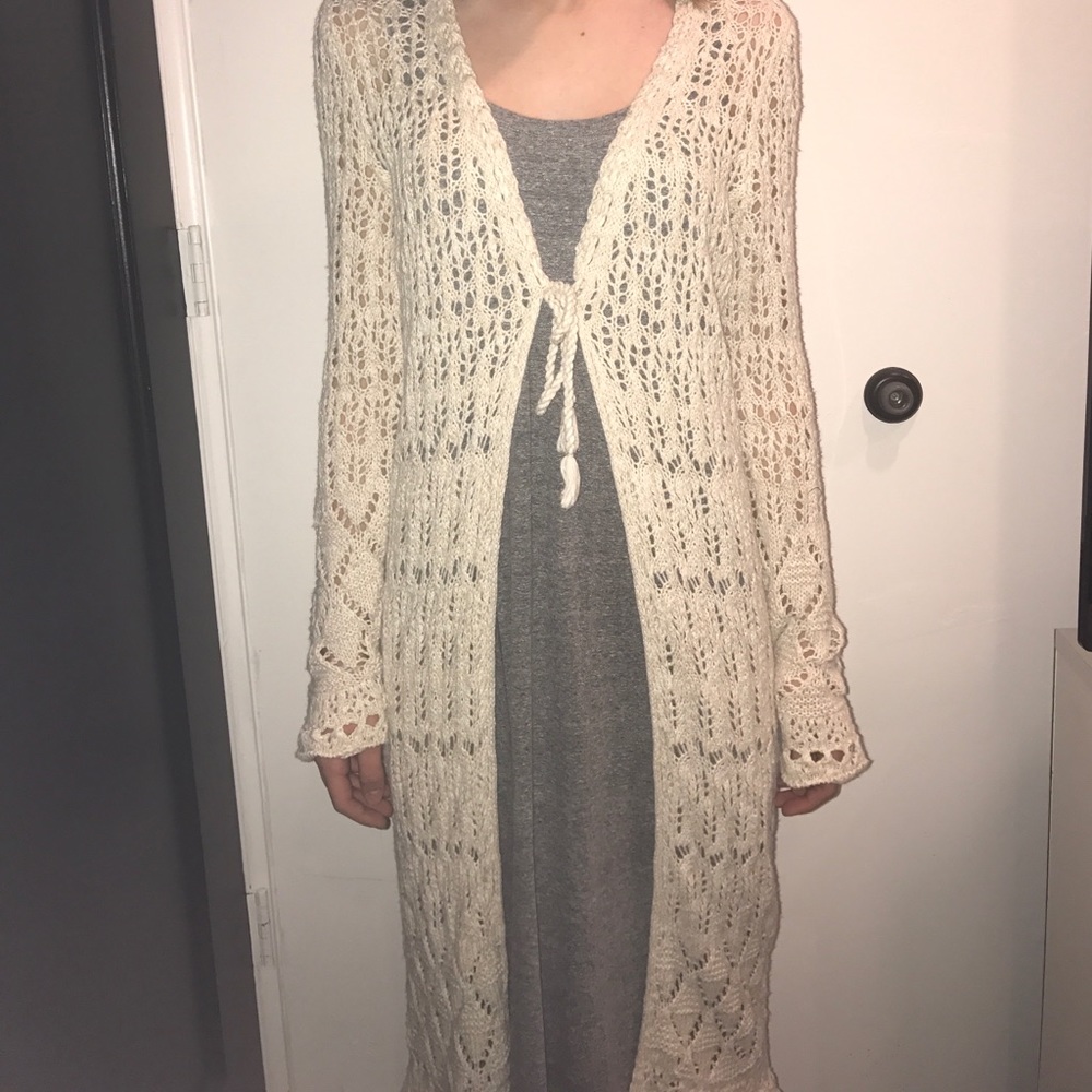 Crocheted cardigan over coat