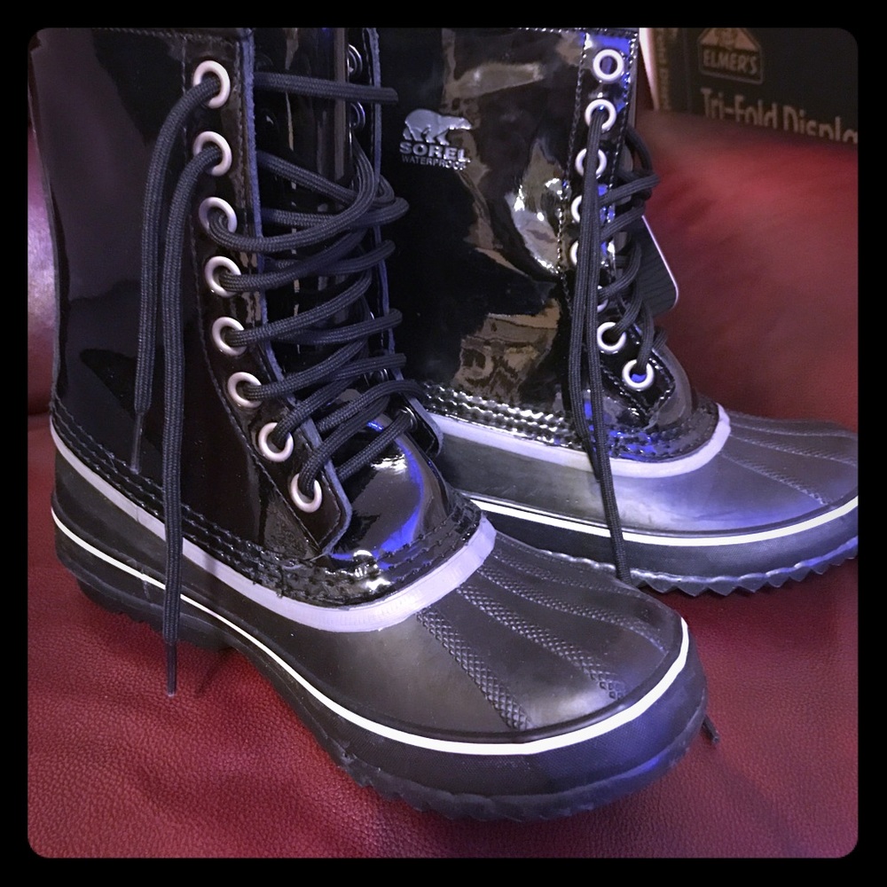 Sorel 1964 patent leather snow boots.