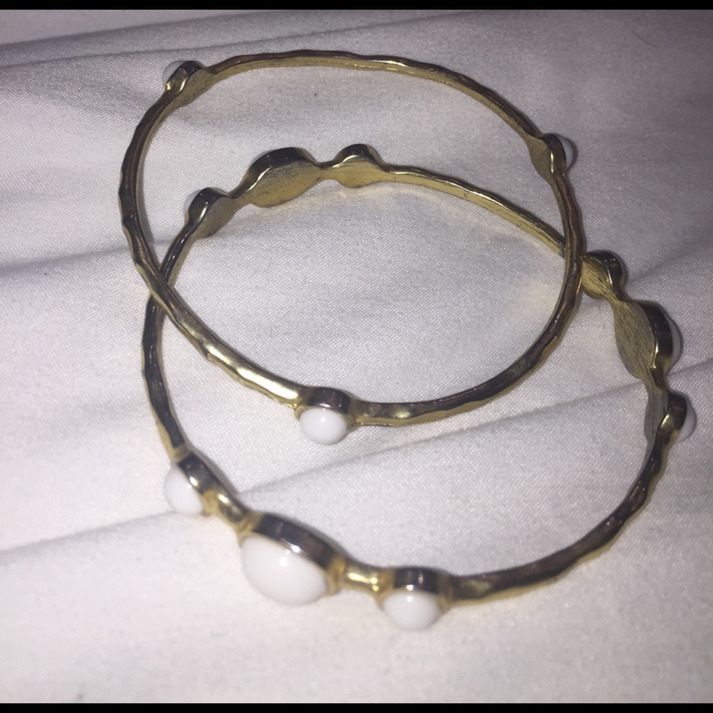 gold bangles set with white stone details