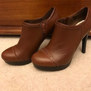 Brown booties with cut out trim.