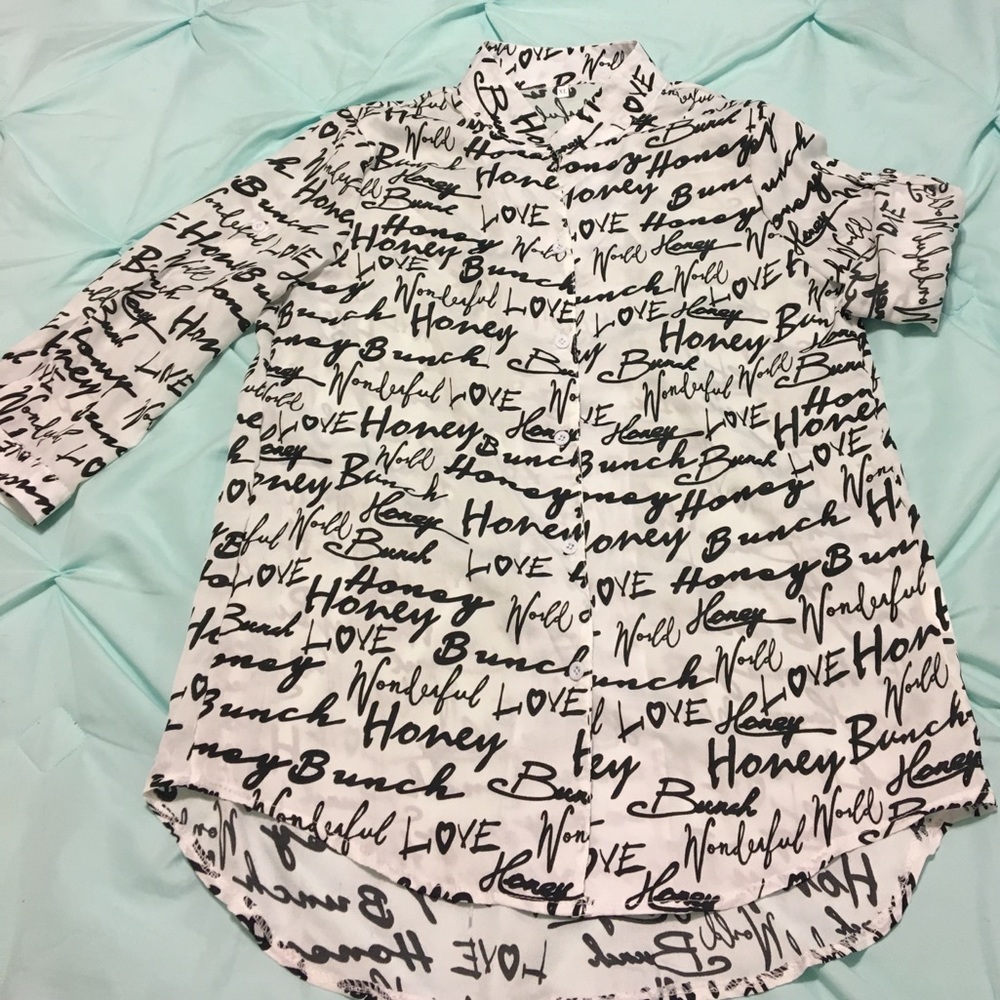 White 3/4 sleeves shirt with black writing.