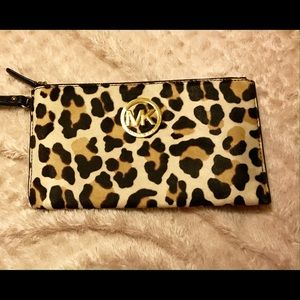 MK haircalf leopard printed zip clutch.