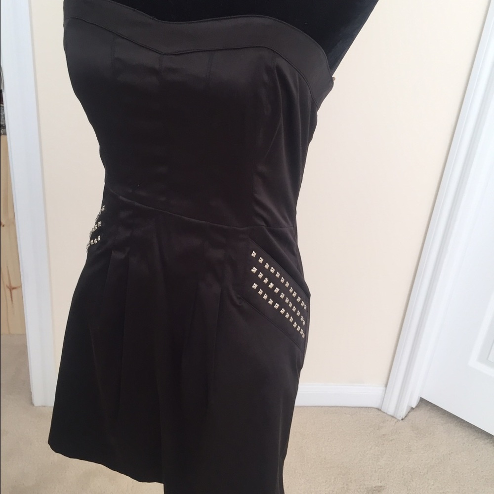 Black strapless dress with studs on pockets.