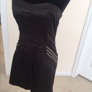 Black strapless dress with studs on pockets.