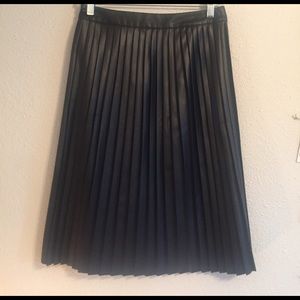 Tea-length black leather pleated skirt