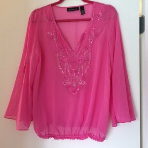 Pink sheer shirt with clear sequin detail.