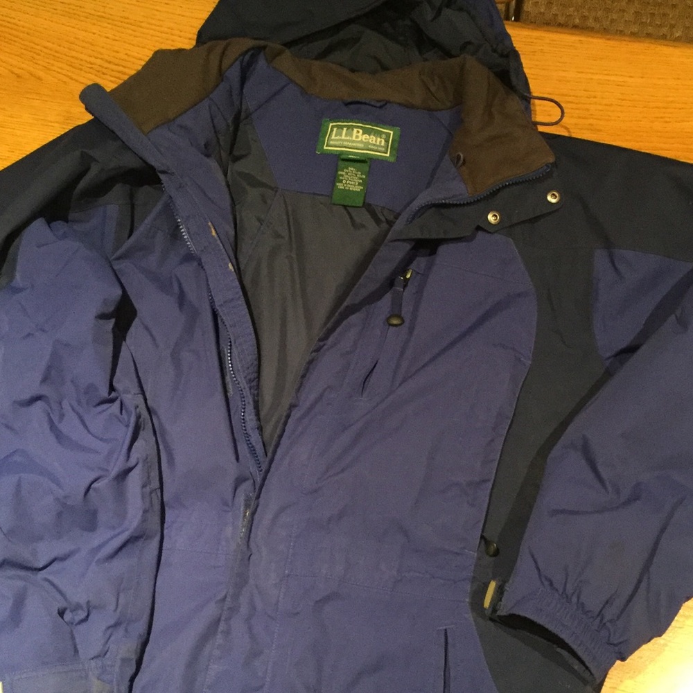 Ski or winter coat with hood.