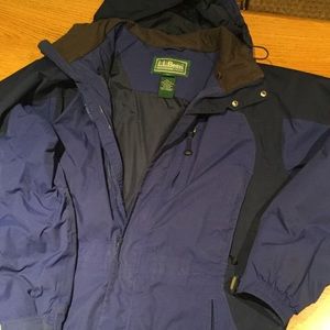 Ski or winter coat with hood.