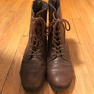 Brown lace up boots.