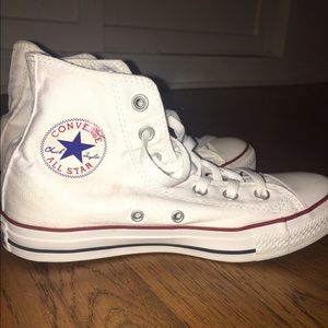 White high top converse, has writing on sole.