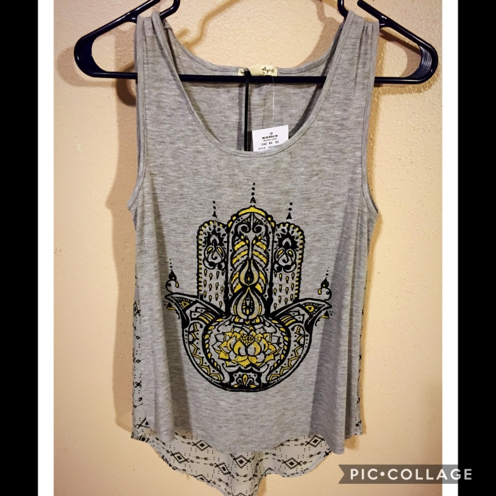 Beautiful tank! Size runs like a medium!