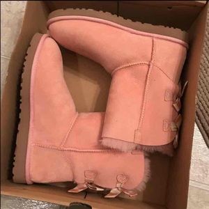 Pink Ugg boots with bow on the back