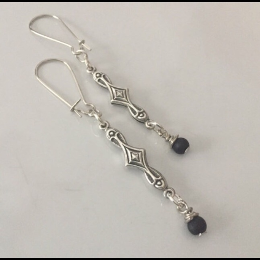 Silver tone straight dangle, small black beads.